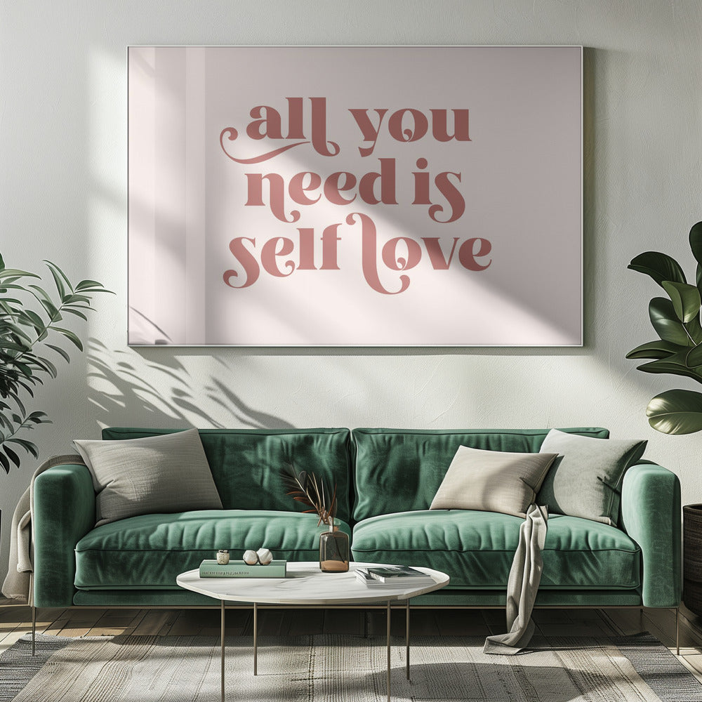 A framed art print with the phrase 'all you need is self love' in a stylish, dusty rose serif font on a light pink background. The artwork is enclosed in a simple silver frame. Poster