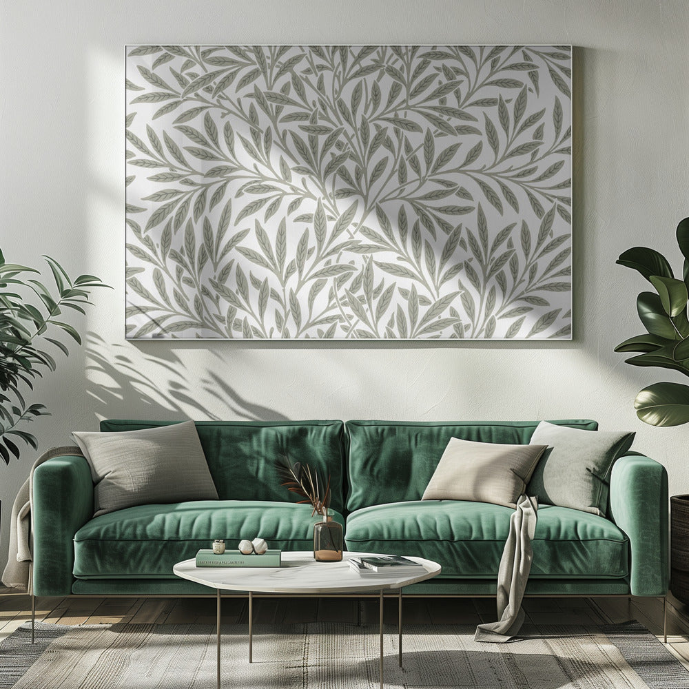 A framed art print displaying a dense pattern of sage green leaves and branches on a white background. The design is continuous and has a calm, naturalistic feel, enclosed within a simple silver frame. Artwork