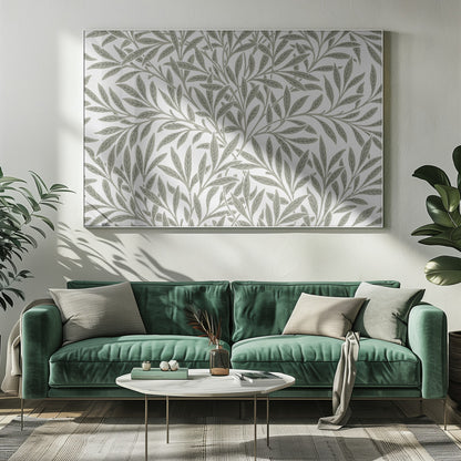 A framed art print displaying a dense pattern of sage green leaves and branches on a white background. The design is continuous and has a calm, naturalistic feel, enclosed within a simple silver frame. Artwork