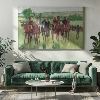 An impressionist painting by Edgar Degas titled 'The False Start', depicting a group of jockeys on their racehorses in a verdant field. The riders are dressed in colorful caps and silks, waiting against a backdrop of rolling green hills and a pale sky. The artwork is displayed in a modern silver frame. Artwork
