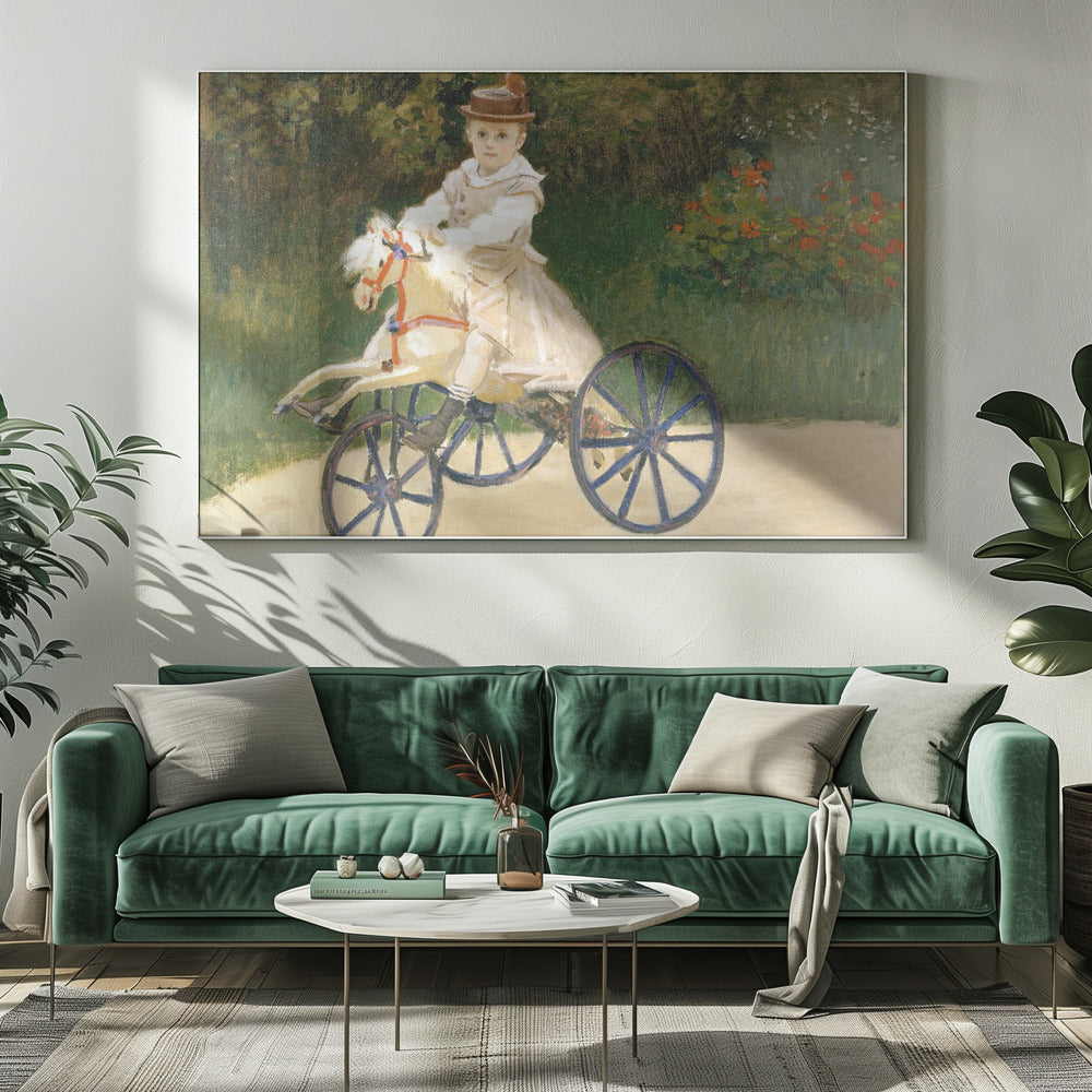 An Impressionist painting by Claude Monet depicting his son, Jean, riding a toy horse tricycle. The young boy wears a brown hat and a light-colored outfit, sitting on a white hobby horse with large blue wheels, set against a lush green garden background. Decor