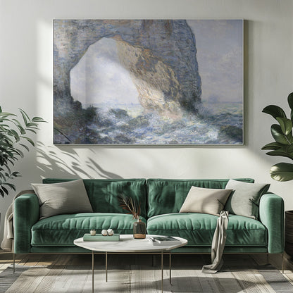 An impressionist painting by Claude Monet of the Manneporte rock arch at Étretat, France. Sunlight illuminates the massive stone arch as turbulent blue and white waves crash against the rocky shoreline below. The artwork is displayed in a silver frame. Decor