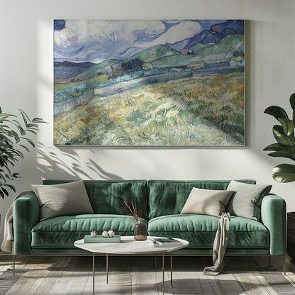 A framed Post-Impressionist painting by Vincent van Gogh depicting a vibrant, rolling landscape. The foreground is filled with swirling brushstrokes of green and yellow fields, leading back to green hills dotted with small houses. In the background, dark blue mountains rise up to meet a dramatic sky filled with large, swirling white clouds against a deep blue. Wall Art