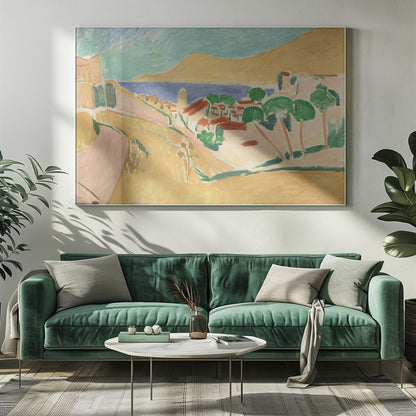 A Fauvist-style painting of a sunny coastal town, enclosed in a silver frame. The scene features warm yellow and pink hills, a village with red-roofed buildings and vibrant green trees, set against a deep blue sea and a large golden hill under a light blue sky. Print