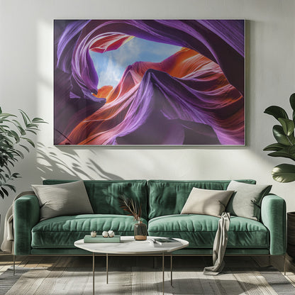 A low-angle photograph looking up from inside a vibrant slot canyon. The smooth, flowing sandstone walls are colored in rich shades of purple, red, and orange, curving around an opening that reveals a bright blue sky with wispy clouds. The image is presented within a silver-colored frame. Wall Art