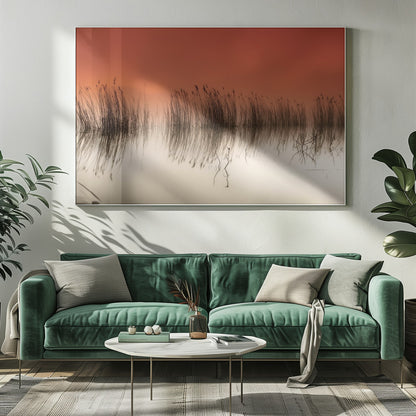 A minimalist landscape photograph in a silver frame, showing dark reeds silhouetted against a vibrant solid orange sky. The calm water perfectly reflects the reeds and the warm glow of the sky, creating a serene and abstract scene. Print
