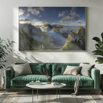 A breathtaking panoramic photograph of the Lofoten Islands in Norway from a high vantage point. A person stands on a rocky cliff with arms outstretched, overlooking a stunning landscape of deep blue fjords, lush green mountains, and the small fishing village of Reine below. The sky is a vibrant blue with scattered white clouds. Artwork