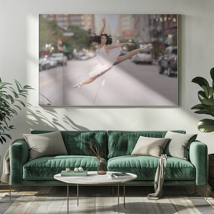 A ballerina in a white tutu and pointe shoes leaps into a split mid-air in the middle of a blurred city street, her arms extended gracefully. The image is set within a silver frame. Print
