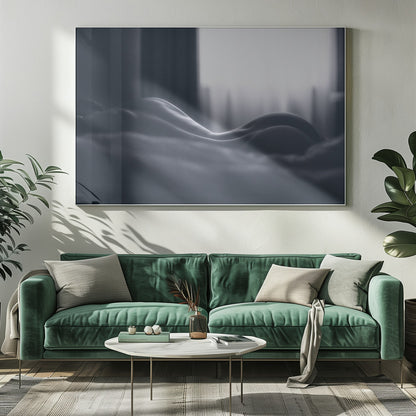 A close-up black and white artistic photograph capturing the soft curves of a person's back and hips as they lie down. The background is softly lit by a window, creating a play of light and shadow that emphasizes the human form's abstract, sculptural qualities. The image is displayed in a silver frame. Print