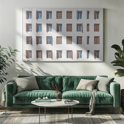 A symmetrical architectural photo of a modern white building facade featuring a grid of twenty-eight windows with wooden louvered shutters, some open and some closed, creating a varied pattern, all within a brushed silver frame. Decor