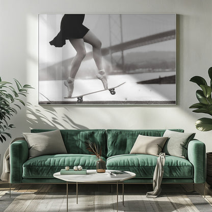 A black and white photograph of a ballerina's legs in a black dress, balancing en pointe on a skateboard with a blurred bridge in the background. Artwork