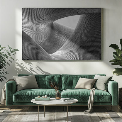A framed, black and white abstract photograph of a swirling, textured structure. The low-angle shot looks up at curving walls made of thin, parallel lines, creating a dynamic sense of movement and depth, with an opening to a bright sky at the top. Artwork