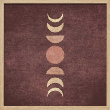 A minimalist piece of framed art showing the phases of the moon arranged vertically against a textured, deep maroon background. The moon shapes are colored in shades of cream and dusty rose, with the full moon in the center. Print