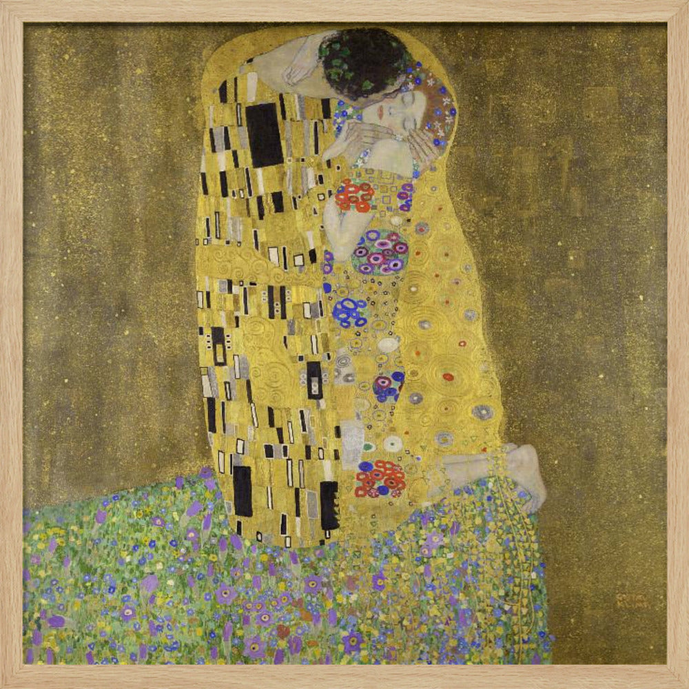 A framed print of Gustav Klimt's famous painting, 'The Kiss'. It features a couple in a passionate embrace, adorned in ornate, patterned golden robes. They are kneeling on a vibrant bed of flowers against a shimmering, textured gold background. Print