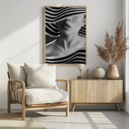 A mysterious black and white close-up portrait of a woman wearing a large, floppy hat with bold black and white stripes. The hat's brim covers her eyes, revealing only her nose, full lips, and chin, creating an elegant and enigmatic look. Decor
