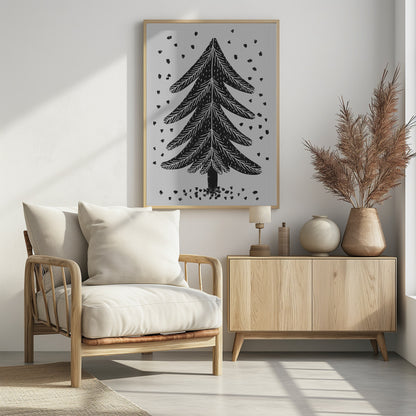 A black and white block print illustration of a stylized Christmas tree against a light gray background. Black specks representing falling snow surround the tree. The artwork has a rustic, folk art feel and is presented in a black frame. Print