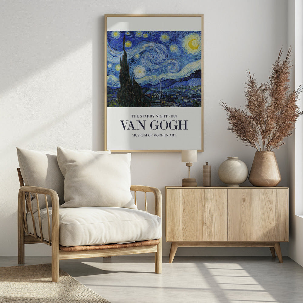 A framed art print of Vincent van Gogh's 'The Starry Night' from 1889. The painting depicts a dramatic, swirling night sky in deep blues and yellows, with a bright crescent moon and glowing stars. A large, dark cypress tree stands in the foreground, reaching towards the sky, with a peaceful village nestled in the hills below. The poster has a white border at the bottom with the text 'THE STARRY NIGHT - 1889', 'VAN GOGH', and 'MUSEUM OF MODERN ART'. Wall Art