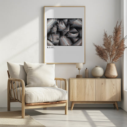 A framed art print of a Paul Klee abstract painting. The artwork is a complex composition of geometric shapes, including triangles, squares, and arcs, in a muted palette of grays, browns, and light blues. The name 'KLEE.' is printed in a black serif font on the white mat below the image. Decor