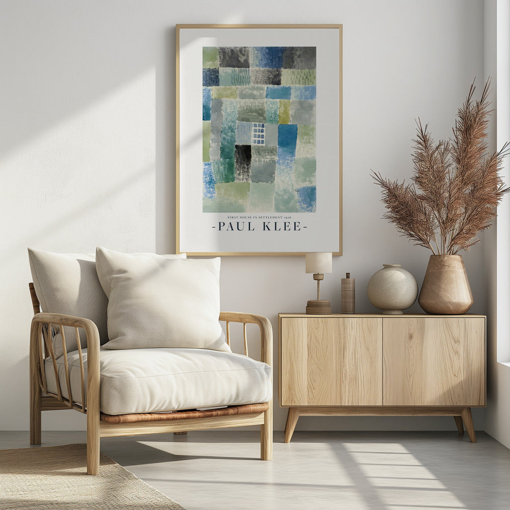 A framed art print of Paul Klee's 1926 painting 'First House in Settlement.' The artwork is an abstract composition of rectangular watercolor blocks in muted shades of blue, green, and grey, arranged in a grid pattern. The title and artist's name are printed below the image. Decor