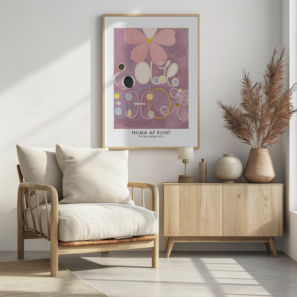 A framed art print of Hilma af Klint's painting 'The Ten Largest, No. 5'. The abstract artwork features a large pink flower at the top against a lavender background, with large, stylized white letters and symbols below, accented with circles of yellow, blue, and black. Poster