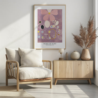 A framed art print of Hilma af Klint's painting 'The Ten Largest, No. 5'. The abstract artwork features a large pink flower at the top against a lavender background, with large, stylized white letters and symbols below, accented with circles of yellow, blue, and black. Poster