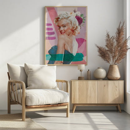 A framed, collage-style portrait of Marilyn Monroe smiling over her shoulder. Her classic blonde hair is adorned with pink, white, and burgundy flowers. She wears bright red lipstick and a blue strapless dress. The background is a textured composition of abstract shapes in shades of pink, purple, and beige, with modern teal and purple brushstrokes layered across the image. Decor