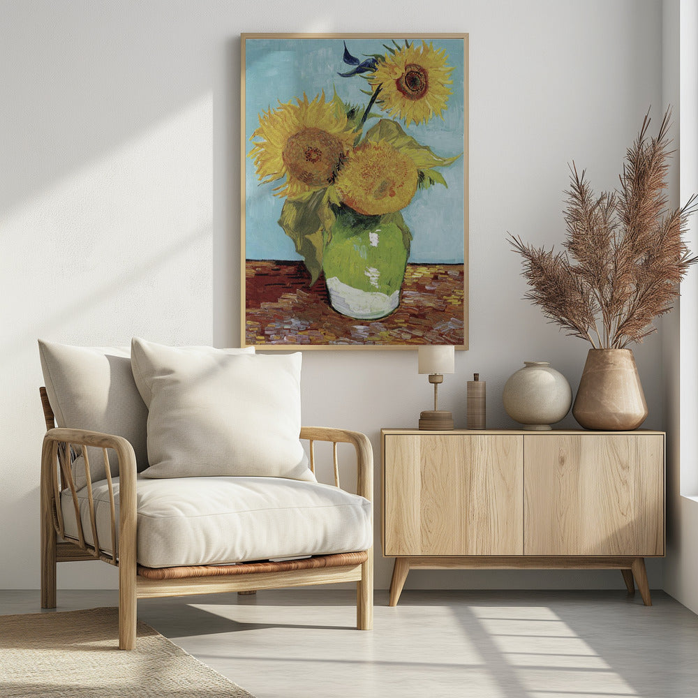 A framed reproduction of Vincent van Gogh's famous 'Sunflowers' painting, featuring three large yellow sunflowers in a green vase against a light blue background, painted in his iconic post-impressionist style with thick brushstrokes. Wall Art