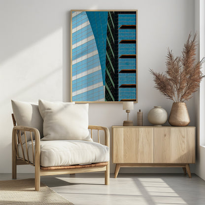 An abstract close-up photograph of modern skyscrapers, featuring a dynamic composition of intersecting lines and geometric patterns. The facades consist of blue, white, and dark green reflective glass, creating a visually complex play of light, shadow, and color. Wall Art