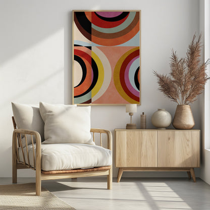 An abstract geometric artwork in a black frame, divided into quadrants. It features large, colorful concentric arcs in shades of orange, red, black, brown, and yellow, creating a dynamic and retro composition against a textured peach and off-white background. Artwork