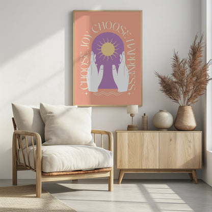An inspirational art print featuring a peach background and a central design. Two white hands hold a purple archway that frames a yellow sun. The words 'Choose Joy' and 'Choose Happiness' curve around the central image in a tan font. Wall Art