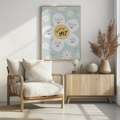 An inspirational poster in a black frame with a light green background and scattered daisy flowers. A large central daisy has 'The power of YET' in its yellow center. Each of its five white petals displays a negative self-talk phrase, such as 'I can't do this..' or 'I'm not good at this..', followed by the word 'YET' in bold, promoting a growth mindset. Print