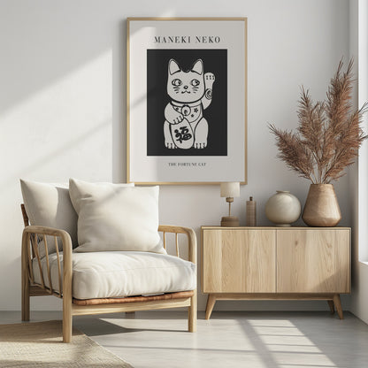 A modern black and white art print of a Japanese Maneki Neko, or fortune cat. The stylized white cat is set against a dark gray background, with the text 'MANEKI NEKO' above and 'THE FORTUNE CAT' below, all enclosed in a thin black frame. Artwork