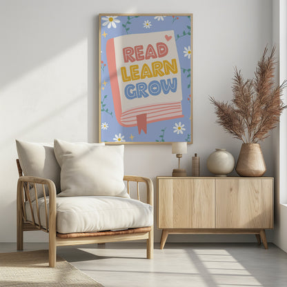 A cheerful illustration of an open book with the words 'READ LEARN GROW' written in colorful, playful letters. The background is light blue with white daisies, green vines, and yellow sparkles, creating a positive and educational theme. Poster