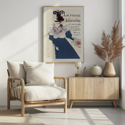 A vintage French poster for 'La revue blanche' by Toulouse-Lautrec. The Art Nouveau illustration features a stylish woman in a blue dress with red polka dots, a large grey fur stole, and a white hat with a prominent black feather plume against a cream background with text. Print