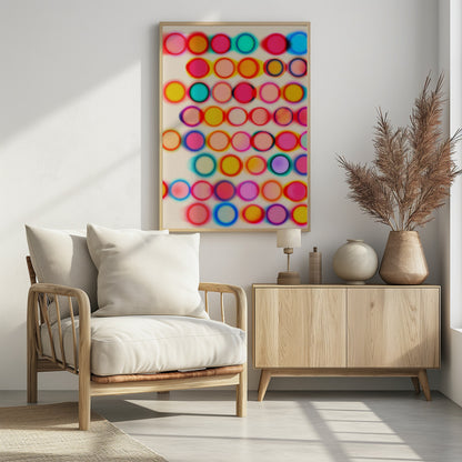 An abstract artwork in a black frame featuring rows of colorful, blurry circles on a cream background. The circles, in shades of pink, yellow, blue, and orange, have a soft-focus, glowing effect and overlap, creating a vibrant, energetic pattern with a slight 3D appearance. Poster