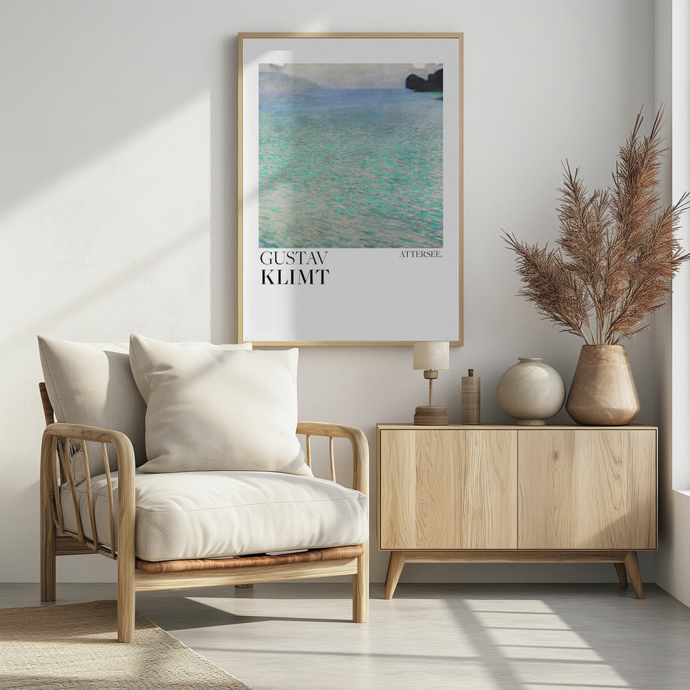 A poster of Gustav Klimt's painting 'Attersee', featuring a tranquil, impressionistic view of a lake with shimmering turquoise and green water under a muted blue and gray sky. The artwork is presented in a modern format with the artist's name and the painting's title below, all within a thin black frame. Poster