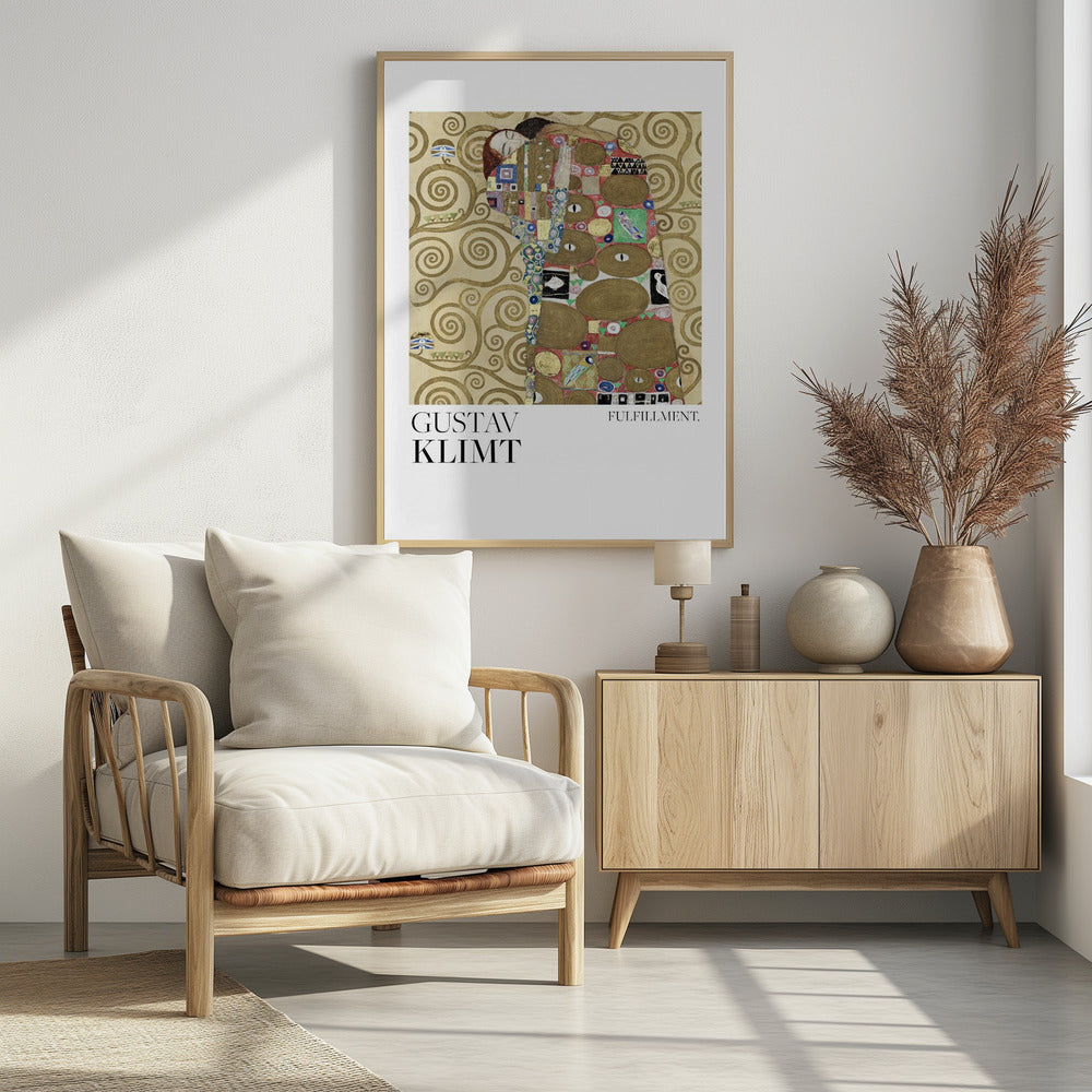 A framed poster of Gustav Klimt's painting 'Fulfillment'. It features a stylized man and woman embracing, wrapped in ornate, mosaic-like robes against a background of golden swirls. Below the image is the text 'GUSTAV KLIMT' and 'FULFILLMENT.'. Wall Art