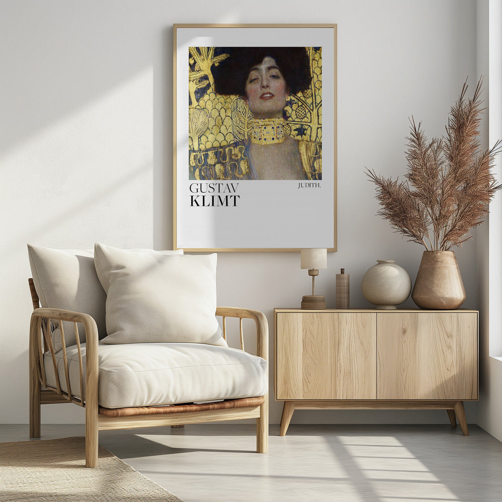 A framed art print of Gustav Klimt's painting 'Judith I'. The artwork features a portrait of a woman with dark hair and a gold choker against a lavish gold-leaf background. The artist's name and the title 'JUDITH.' are printed below the image on a white border. Print