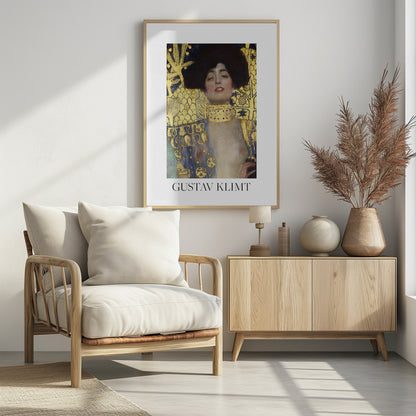 A fine art poster of Gustav Klimt's painting 'Judith and the Head of Holofernes'. The artwork depicts a woman with dark, styled hair and a sensual expression, wearing a large, ornate gold choker. Her body is partially draped in a blue and gold patterned garment, against a richly decorated gold leaf background. The poster is presented in a black frame with a white border, and the artist's name is printed at the bottom. Wall Art