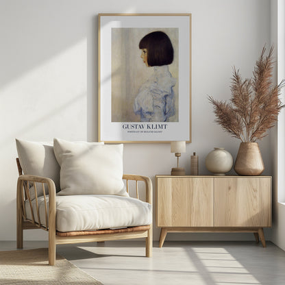 A framed art print of Gustav Klimt's 'Portrait of Helene Klimt'. The painting shows a young girl in profile with a dark bob haircut and a high-collared, ruffled light blue dress against a textured beige background. The artist's name and the painting's title are printed at the bottom. Wall Art