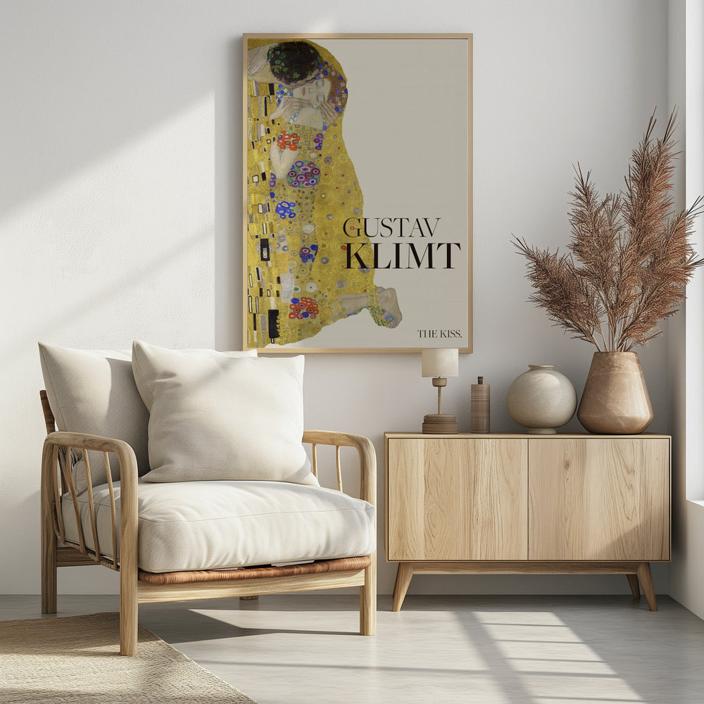 A poster of Gustav Klimt's painting 'The Kiss' featuring an embracing couple enveloped in ornate, golden robes. The artist's name 'GUSTAV KLIMT' and the title 'THE KISS' are printed in black text on a cream background, all within a black frame. Artwork
