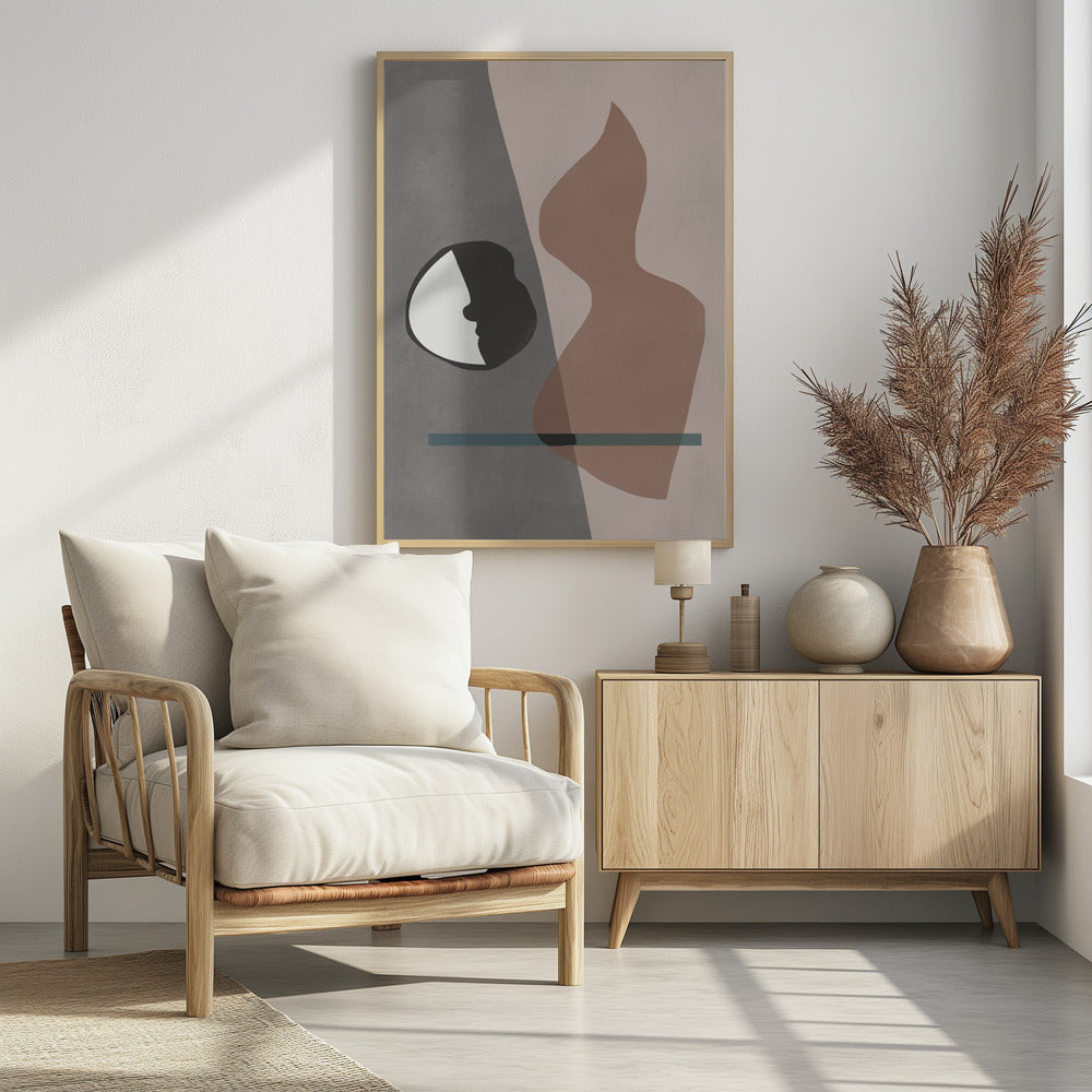 A modern abstract artwork in a black frame, featuring a composition of layered shapes in muted tones. The background is split between gray and pale pink, with a black and white circular element showing a face profile, a large translucent brown organic shape, and a horizontal teal line. Decor