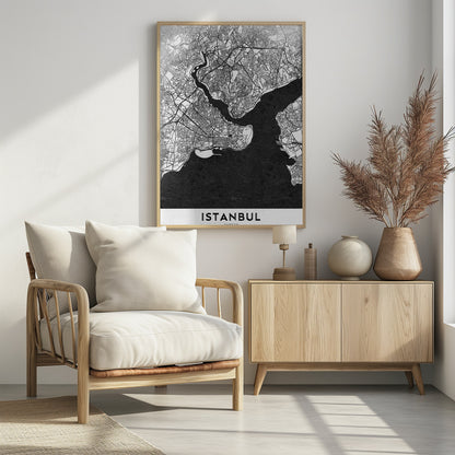 A modern black and white framed poster of a city map of Istanbul. The land is depicted in white with intricate black lines representing streets, while the bodies of water like the Bosphorus are shown in solid textured black. A white banner at the bottom displays the word 'ISTANBUL' in a bold, black, sans-serif font. Artwork