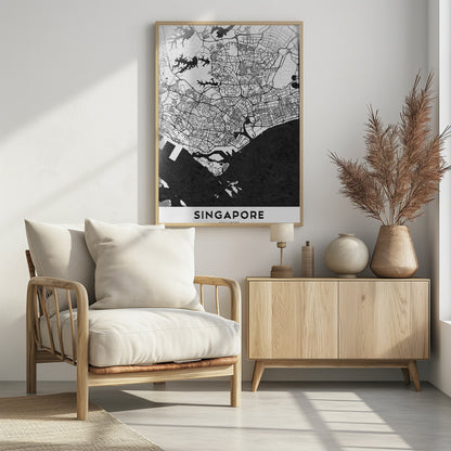 A framed, minimalist black and white art print of a map of Singapore. The land and road network are depicted in white with intricate black lines, while the surrounding water is a solid, textured black. At the bottom, the word 'SINGAPORE' is printed in black capital letters on a white banner. Decor