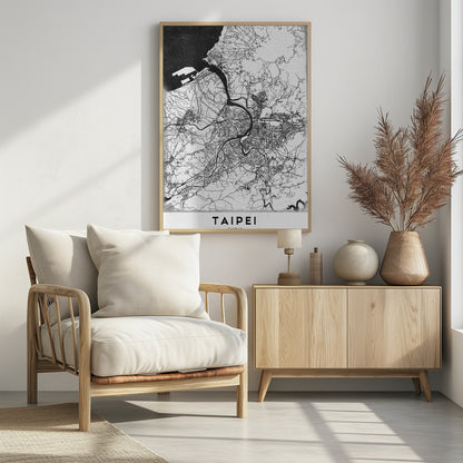 A minimalist black and white map of Taipei, Taiwan, styled as a poster. The intricate network of roads and rivers is rendered in thin black lines on a white background, with the ocean shown in solid black. The word 'TAIPEI' is printed in large, bold capital letters at the bottom. The entire map is enclosed within a thin black frame. Print