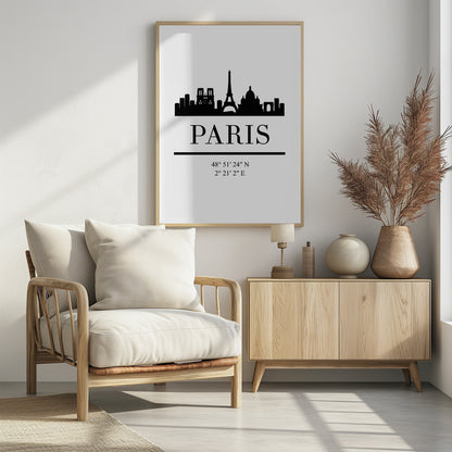 A minimalist black and white poster in a black frame. It features a black silhouette of the Paris skyline, including the Eiffel Tower and Notre Dame. Below the city is the word 'PARIS' in a large serif font, followed by its geographical coordinates. Poster