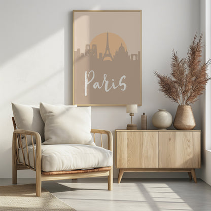 A minimalist art print of the Paris skyline in muted tan and beige tones. Silhouettes of the Eiffel Tower and other landmarks stand before a large, pale orange sun. The word 'Paris' is written in a white, flowing script in the foreground. Artwork
