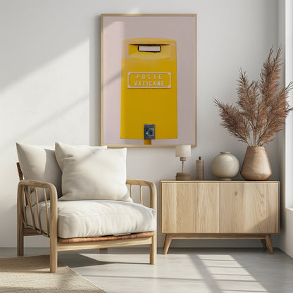 A close-up, front-view photograph of a vibrant yellow Vatican City mailbox against a plain beige wall, enclosed in a thin black frame. The words 'POSTE VATICANE' are printed in white on the front. Artwork