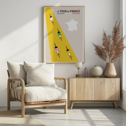 A minimalist poster for Le Tour de France featuring an overhead view of four cyclists on a bright yellow road that cuts diagonally across a beige background. The cyclists wear the iconic white, green, red polka-dot, and yellow jerseys. The title 'LE TOUR de FRANCE' is at the top, and a white silhouette of the map of France is in the upper right corner. Print