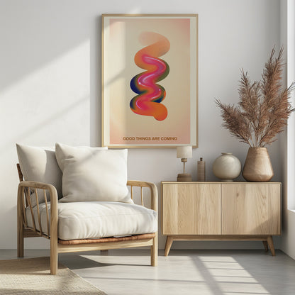 A framed modern art poster with a cream-colored, textured background. In the center is a glossy, 3D spiral shape with a vibrant color gradient of pink, orange, blue, and green. At the bottom, the motivational phrase 'GOOD THINGS ARE COMING' is printed in a simple, orange-brown font. Decor